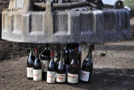 Some of more than 500 bottles of wine found to be counterfeit or unsellable are shown as they are being destroyed at a landfill in Creedmoor, Texas in this December 10, 2015 US Marshals photo. REUTERS/Lynzey Donahue/US Marshals/Handout