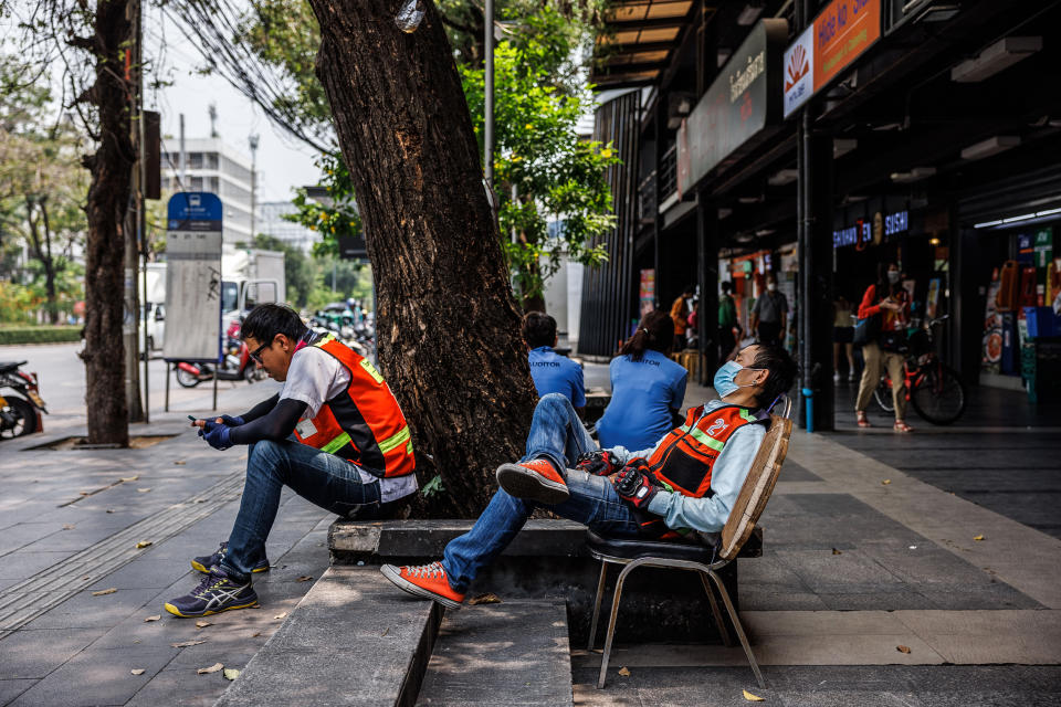 Motorbike taxi drivers rest in the shade during a heat wave in Bangkok on April 27, 2023.  (Andre Malerba / Bloomberg via Getty Images file)