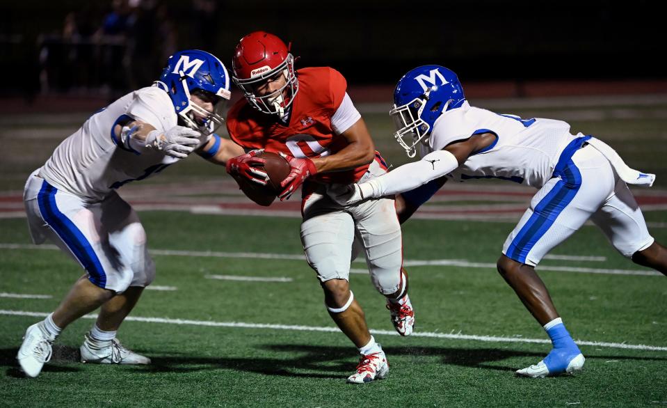 Brentwood Academy’s Kolbe Harmon (0) runs against McCallie linebacker Carson Gentle, left, and defensive back Marcellus Barnes, right, during an high school football game Friday, Sept. 15, 2023, in Brentwood, Tenn.