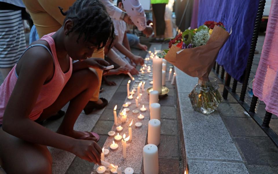 Prayers are said and candles are lit outside Notting Hill Methodist Church near the 24 storey residential Grenfell Tower block in Latimer Road - Credit: Getty