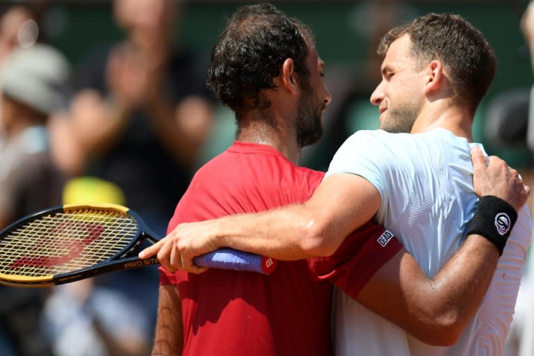 Great job: Grigor Dimitrov is congratulated by Mohamed Safwat