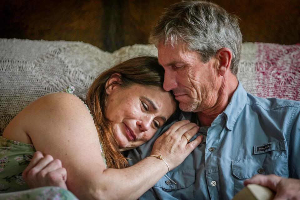Kim and Adam Crump are overcome with emotion as they hold their son Hunter's urn while remembering him this summer. Hunter, 18, died from a fentanyl overdose in June 2022, a few weeks after graduating from Taylor High School.