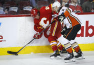 Anaheim Ducks' Kevin Shattenkirk, right, checks Calgary Flames' Brett Ritchie during the second period of an NHL hockey game in Calgary, Alberta, Monday, Oct. 18, 2021. (Jeff McIntosh/The Canadian Press via AP)