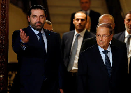 Christian politician and FPM founder Michel Aoun (L) walks next to Lebanon's former prime minister Saad al-Hariri after he said he will back Aoun to become president in Beirut, Lebanon October 20, 2016. REUTERS/Mohamed Azakir