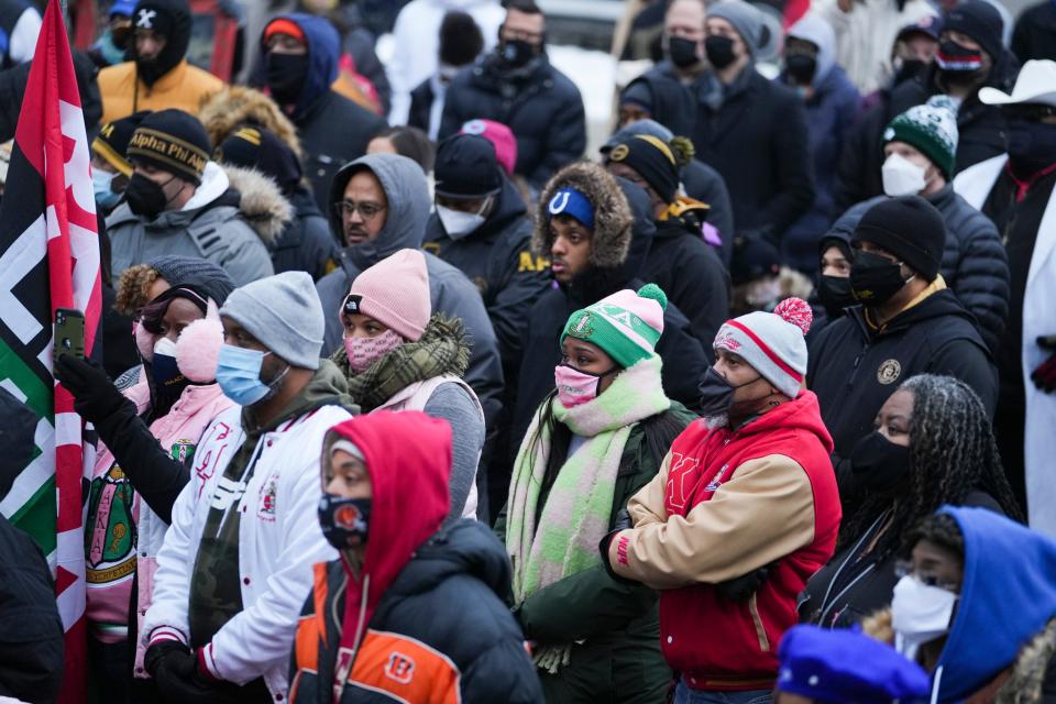 The audience at Monday's annual MLK Day March in Downtown Columbus listens as Linden Young, a senior at Franklin Heights High School, talks about how the world has become polarized, keeping people from making connections with one another.