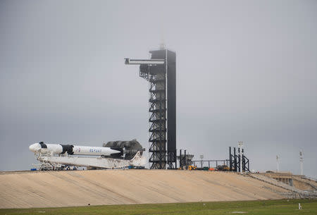 A SpaceX Falcon 9 rocket with the company's Crew Dragon spacecraft onboard is seen as it is rolled out of the horizontal integration facility at Launch Complex 39A as preparations continue for the Demo-1 mission at the Kennedy Space Center in Cape Canaveral, Florida, U.S., February 28, 2019. Joel Kowsky/NASA/Handout via REUTERS