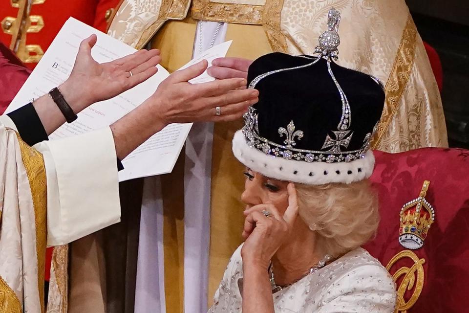 Camilla adjusts her hair under the weight of the crown as she is proclaimed queen by the Archbishop of Canterbury (POOL/AFP via Getty Images)