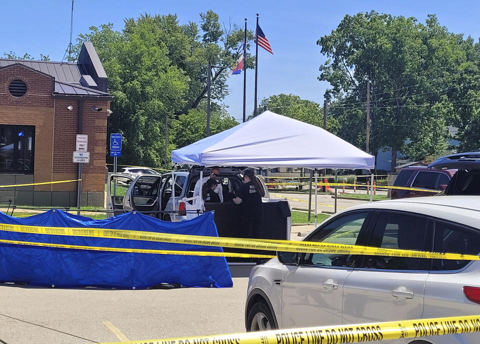 Law enforcement officers investigate a vehicle that was driven to Festus City Hall and Police Station, Tuesday morning, May 28, 2024, in Festus, Mo., by a woman who allegedly told officers she killed two of her children. (Tony Krausz/Leader Publications via AP)
