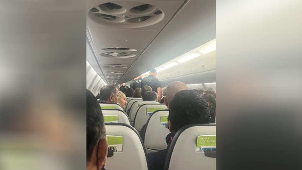 A photo taken by passenger Aubrey Gavello shows police on Flight 2059 after it made an emergency landing in Portland, Oregon, on Sunday.  - Aubrey Gavello/LOCAL NEWS X/TMX