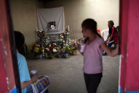 Relatives attend the wake of Juana Martina Villata, a garbage collector who was killed after a massive pile of garbage collapsed and buried her at a landfill dumpsite, at her home in Guatemala City, Guatemala, April 28, 2016. REUTERS/Saul Martinez