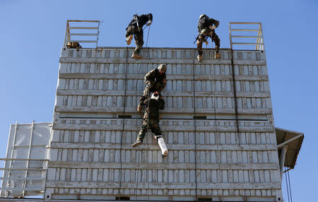 Afghan army Special Forces take part in a military exercise in Rishkhur district outside Kabul, Afghanistan February 25, 2017. Picture taken on February 25, 2017. REUTERS/Omar Sobhani