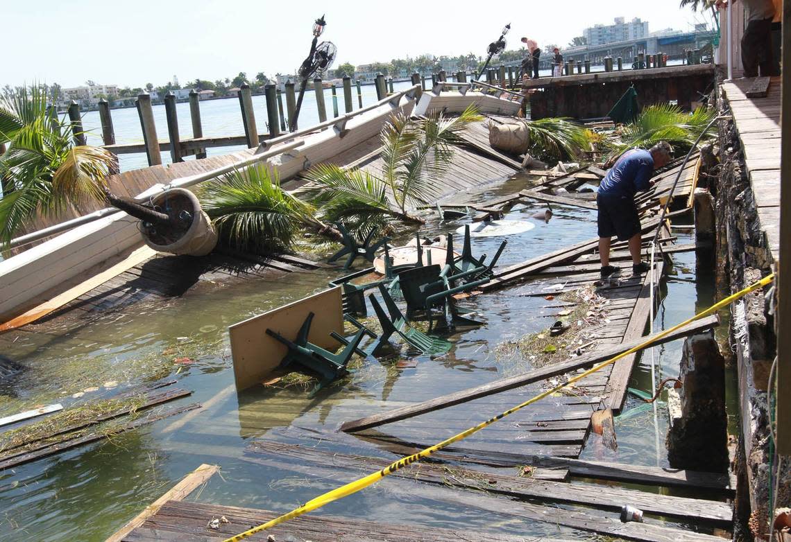 Engineers and investigators examine the collapsed deck at Shuckers, a popular bayfront bar, in North Bay Village, Saturday, June 15, 2013.