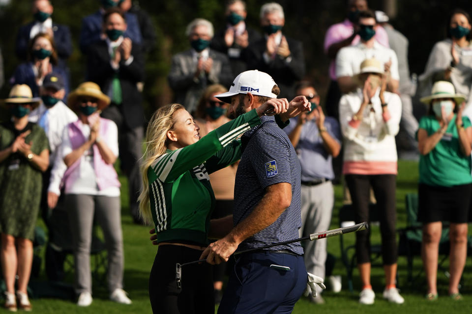 Dustin Johnson is hugged by Paulina Gretzky after winning the Masters golf tournament Sunday, Nov. 15, 2020, in Augusta, Ga. (AP Photo/Matt Slocum)