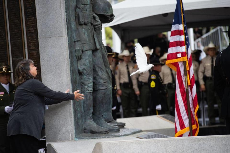 Kathy Dusart, with Doves of White, releases a dove on Monday during the California Peace Officers’ Memorial Ceremony at the state Capitol.