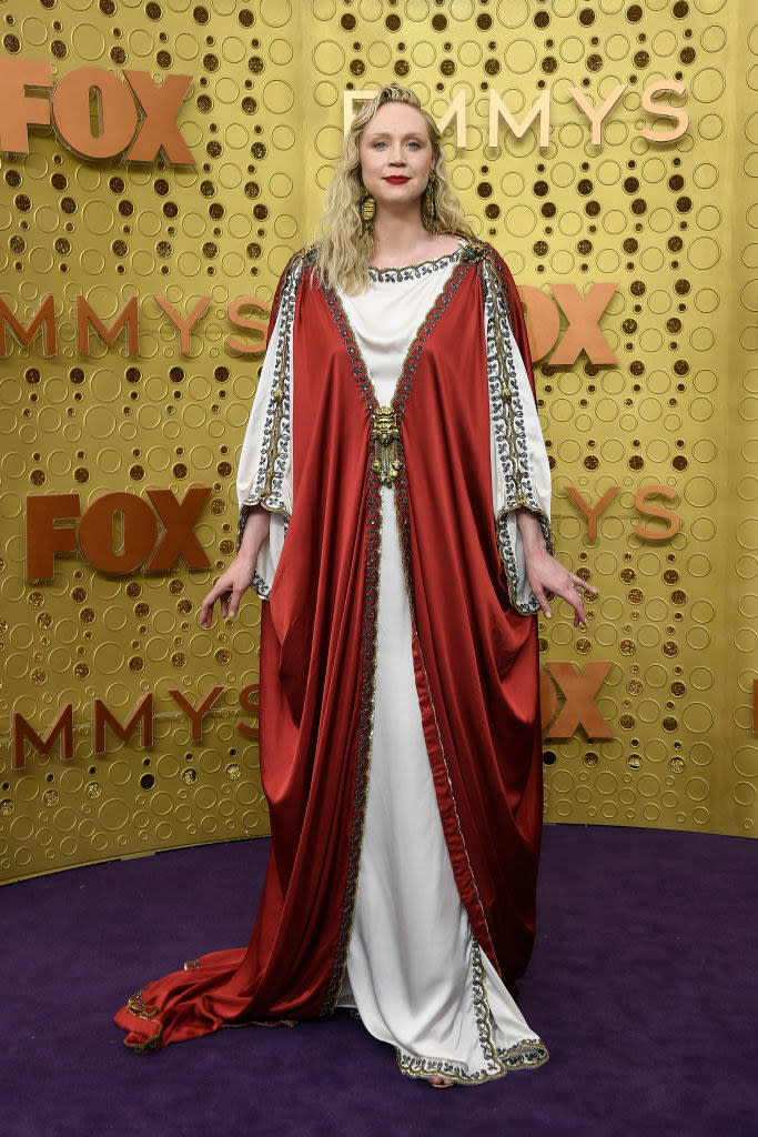 Religious looking garment with long flow sleeves and skirt, a long neckline at the collarbone, a slight cinch at the waist, and a kimono-style draped fabric piece