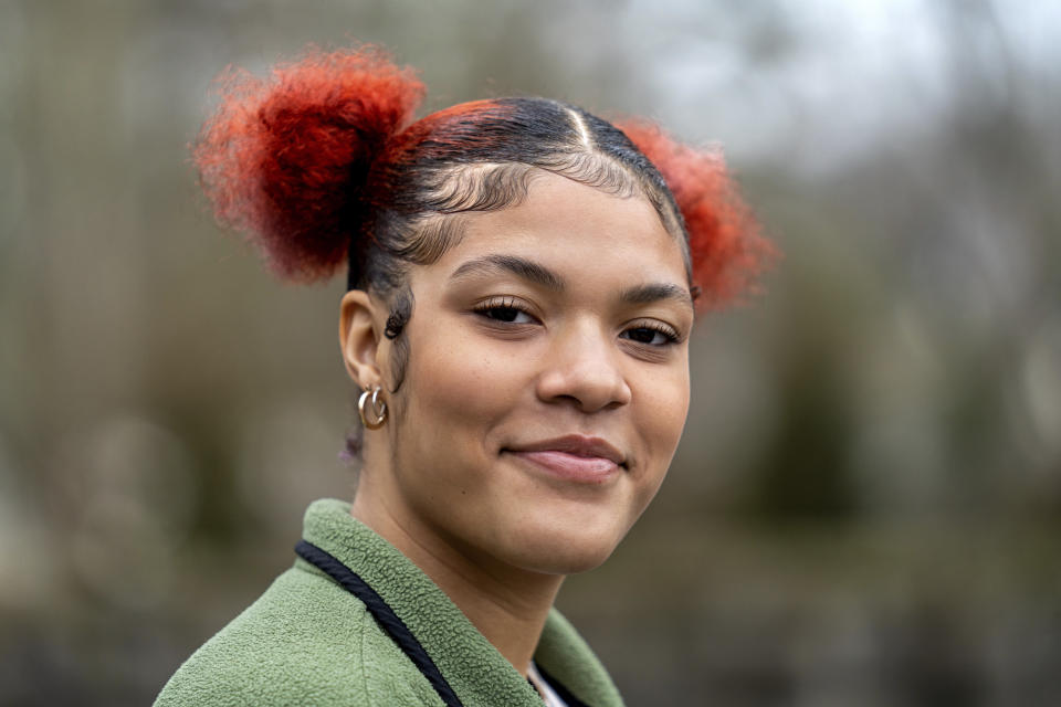 Kailani Taylor-Cribb stands for a portrait at a neighborhood community garden in Asheville, N.C., on Tuesday, Jan. 31, 2023. In ninth grade, a few months before the COVID-19 pandemic hit, she was unhappy at home and had been demoted from honors geometry because of poor grades. (AP Photo/Kathy Kmonicek)