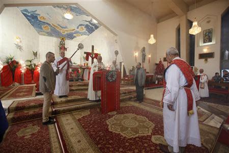 Iraqi Christians attend mass on Christmas at St. Joseph Chaldean Church in Baghdad, December 25, 2013. REUTERS/Ahmed Saad