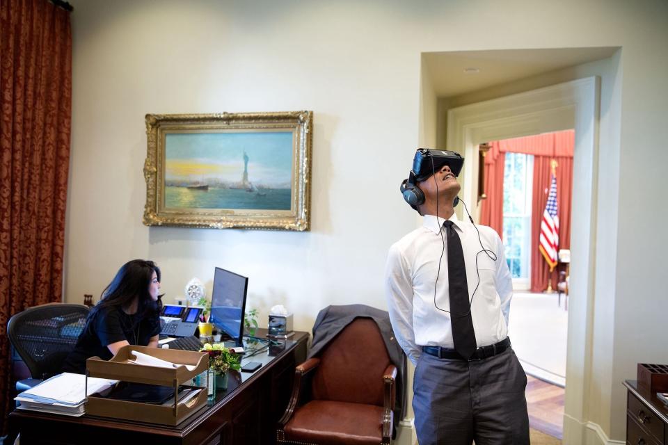 As Govashiri continues working, Obama watches a virtual reality film on Aug. 24 that was captured during his summer trip to Yosemite National Park.