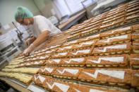 A baker prepares pastry with a bolt sign as a ubiquitous symbol of the protests sweeping across Poland