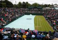 Britain Tennis - Wimbledon - All England Lawn Tennis & Croquet Club, Wimbledon, England - 29/6/16 General view as groundstaff pull the cover over court 2 as rain delays play REUTERS/Paul Childs