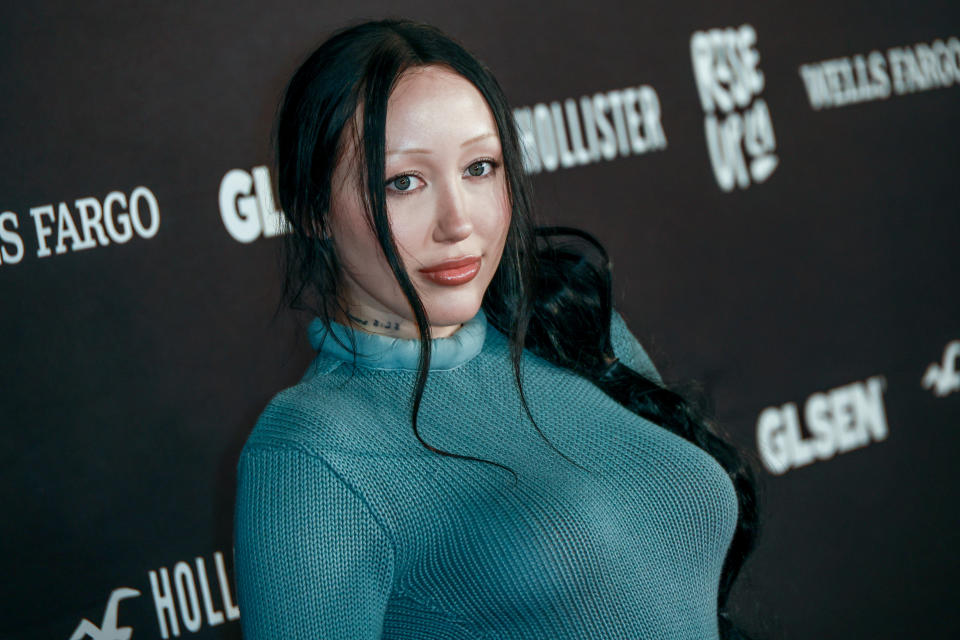 Noah Cyrus wearing a fitted turtleneck dress on the red carpet