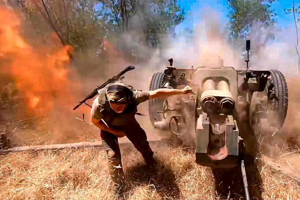 A Russian soldier fires a howitzer toward Ukrainian positions in August.