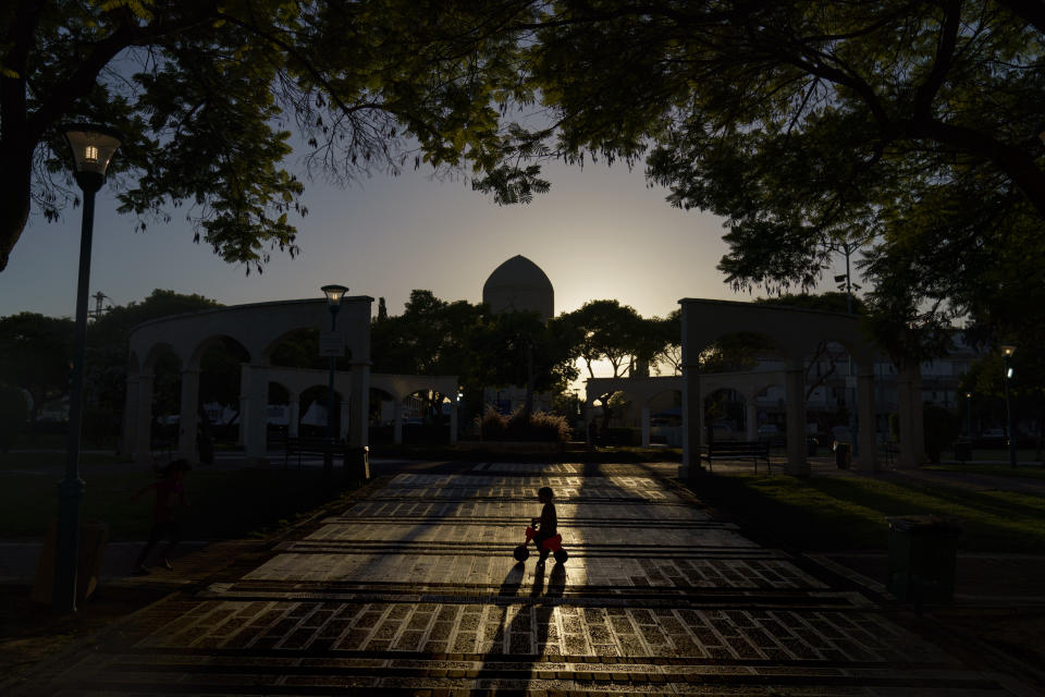 A child plays in a park in the mixed Arab-Jewish town of Lod, central Israel, Thursday, May 27, 2021. Nearly a month after recent clashes between Jews and Arabs, residents are uncertain about the city's shared future. Weeks after the chaos subsided, with the deployment of hundreds of police and gendarmes and declaring a state of emergency, a tense calm has returned to Lod's streets. (AP Photo/David Goldman)