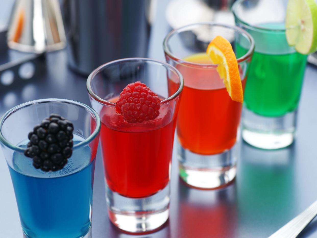 "Four colorful jello shots with fresh fruit garnishes. Same shot vertically, and a bunch of other drinks you desperately need:"