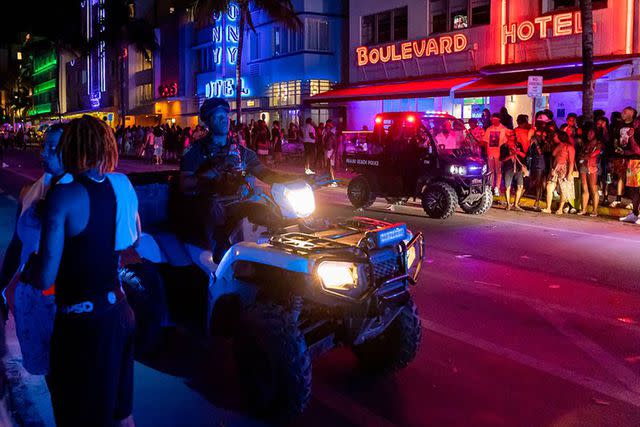 <p>Matias J. Ocner/Miami Herald/Tribune News Service via Getty</p> Police officers breaking up crowds in Miami Beach in March 2023.