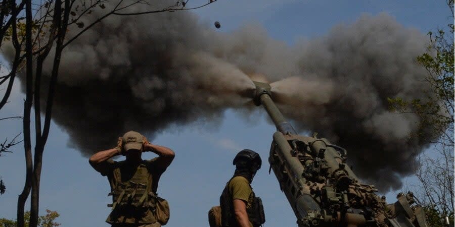 Ukrainian military personnel fire from an M777 howitzer in the Kharkiv region