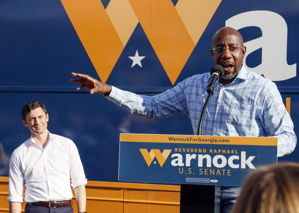 FILE - U.S. Sen. Raphael Warnock, D-Ga., speaks at a campaign event in Clarkston, Ga., on Thursday, Nov. 3, 2022. At left is U.S. Sen. Jon Ossoff, D-Ga. Herschel Walker and Sen. Raphael Warnock meet Tuesday, Nov. 8, in Georgia’s Senate contest that could help determine which party controls the Senate for the next two years. More than 2.5 million Georgia voters have already cast ballots, about a 20% increase over advanced voting in 2018. (AP Photo/Bob Andres, File)