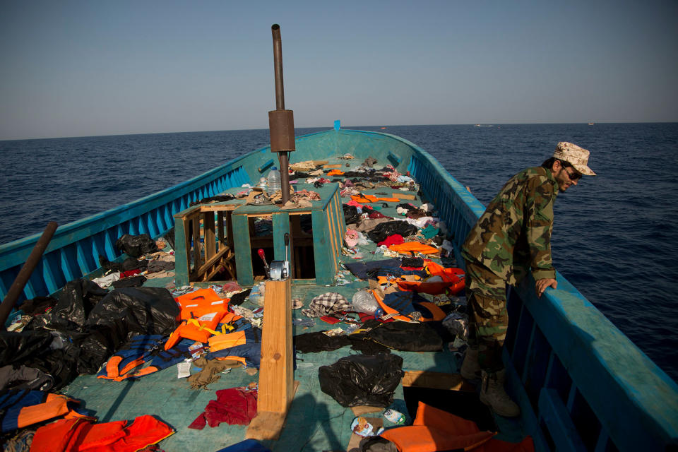 <p>A LIbyan coast guard stands on a wooden boat where more than seven hundred migrants were sailing in to flee Libya, during a rescue operation in the Mediterranean sea, about 13 miles north of Sabratha, Libya, Monday, Aug. 29, 2016. (AP Photo/Emilio Morenatti) </p>