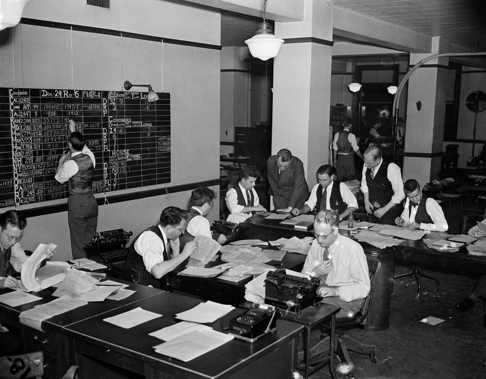 Journalists work on election night in Washington, D.C., Nov. 8, 1938. In background hunched over a writer is Milo Thompson, Washington chief of bureau, who directed the operation. (AP Photo)