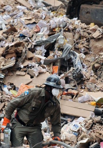 A firefighter works at the site where three buildings collapsed in Rio de Janeiro. There is no hope of finding survivors from the three high-rise buildings that collapsed in central Rio, authorities said Friday, which could bring the final death toll to 26