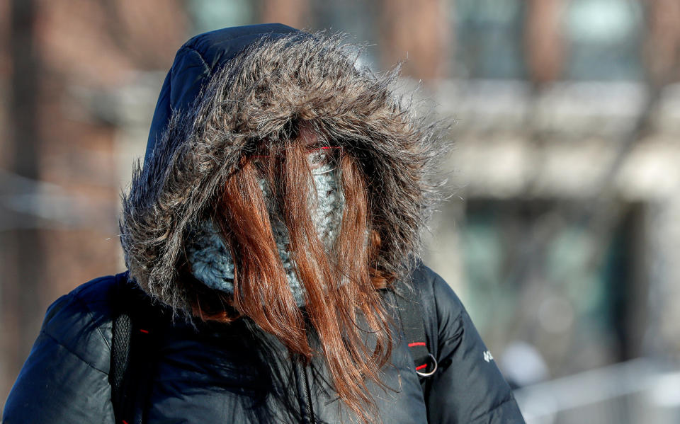 A student is dressed for subzero temperatures while walking to class at the University of Minnesota in Minneapolis, Minnesota.