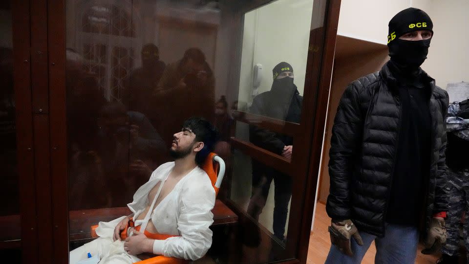 A suspect in Friday's shooting at the Crocus City Hall sits in a wheelchair in the Basmanny District Court in Moscow, Russia, Sunday, March 24, 2024. - Alexander Zemlianichenko/AP