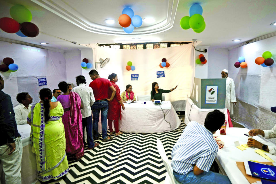 Voters queue up inside a polling booth to cast their vote in the sixth round of polling in India's national election in New Delhi, India, Saturday, May 25, 2024. (AP Photo/Manish Swarup)