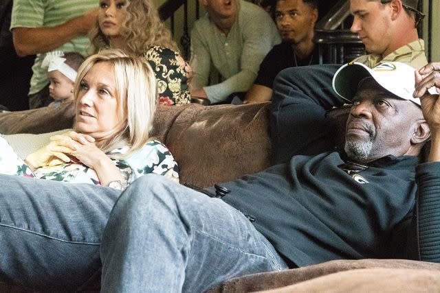 <p>Maximilian Haupt/picture alliance/Getty</p> John Brown and Miriam Brown watch the TV during the NFL draft on April 30, 2021.