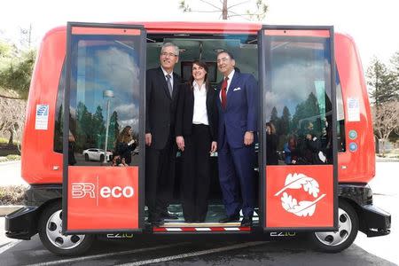 (L-R) Randell Iwasaki, executive director of the Contra Costa County Transportation District, Marion Lheritier, spokeswoman for EasyMile, and Alexander Mehran Sr., chairman and chief executive of Sunset Development Company, pose for a photo on an EasyMile EZ10 shared autonomous vehicle during a deployment demonstration at Bishop Ranch in San Ramon, California March 6, 2017. REUTERS/Stephen Lam