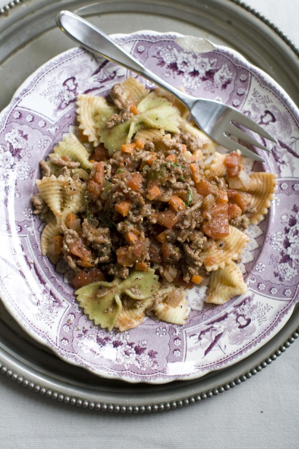 This Dec. 2, 2013 photo shows five spice pork bolognese pasta in Concord, N.H. This Bolognese is mostly effortless. You can make it even more so by using the food processor to chop your vegetables. Just toss them all in at once, then pulse until finely chopped. As for the meat, pork is delicious, but feel free to substitute beef, veal or turkey. (AP Photo/Matthew Mead)