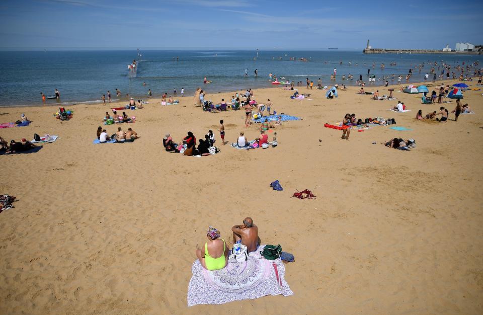 People enjoy the sunshine on the beach and in the sea in Margate, south east England on May 26, 2020, after some lockdown restrictions put in place to slow the spread of COVID-19 were partially eased earlier this month. - Britain's number of deaths "involving" the coronavirus has risen to 46,000, substantially higher than the 36,914 fatalities officially reported so far, according to a statistical update released Tuesday. The daily death tolls released in Britain only include fatalities that have been confirmed by a positive test. (Photo by Ben STANSALL / AFP) (Photo by BEN STANSALL/AFP via Getty Images)