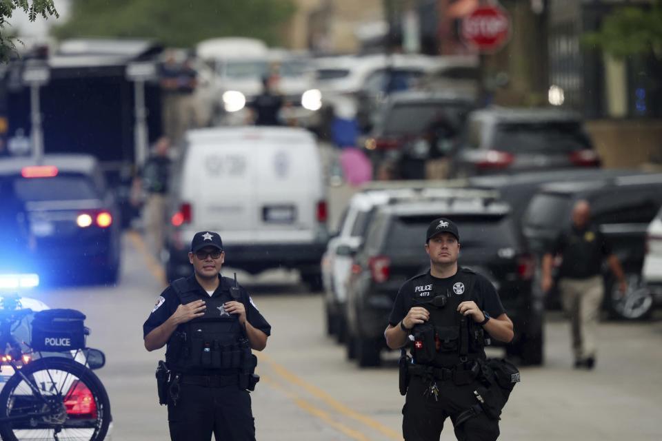 Two officers stand near 2nd and Central avenues at a mass shooting crime scene Monday, July 4, 2022, in Highland Park, Illinois. (John J. Kim/Chicago Tribune/Tribune News Service via Getty Images)