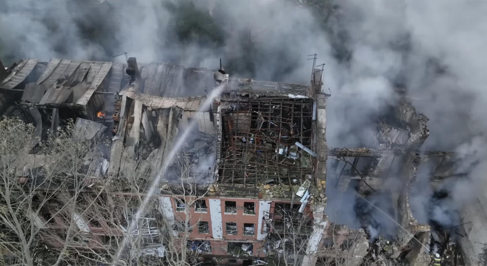 In this image taken from video provided by the Ukrainian Emergency Service, emergency service personnel work at a scene of a destroyed residential area after a Russian attack in Mykolaiv, Ukraine, Thursday, July 20, 2023. (Ukrainian Emergency Service via AP)