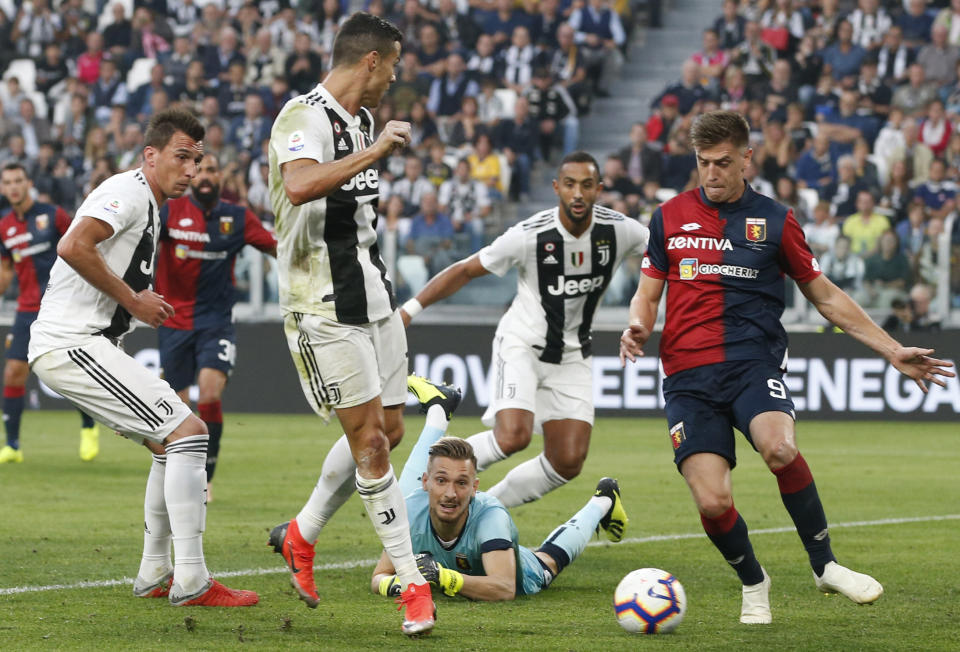 Juventus' Cristiano Ronaldo, second from left, scores his team's first goal during an Italian Serie A soccer match between Juventus and Genoa, at the Alliance stadium in Turin, Italy, Saturday, Oct. 20, 2018. (AP Photo/Antonio Calanni)