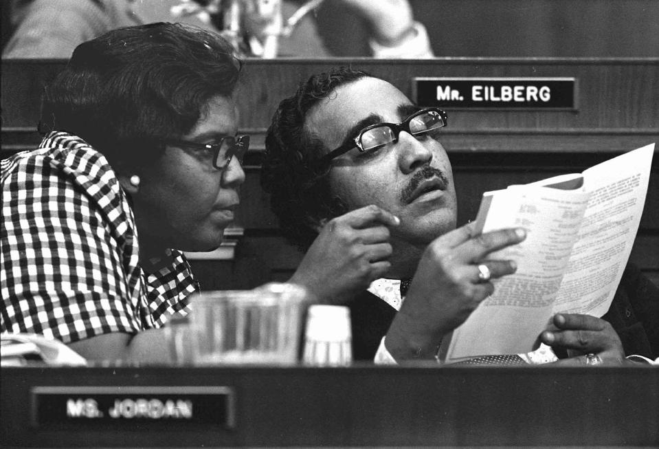 Barbara Jordan and Charles Rangel look at a book during a hearing