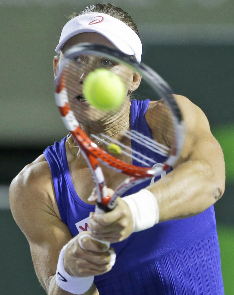 Samantha Stosur, of Australia, returns a shot from Coco Vandeweghe, of the United States, at the Sony Open tennis tournament, early Sunday, March 23, 2014, in Key Biscayne, Fla. (AP Photo/Wilfredo Lee)