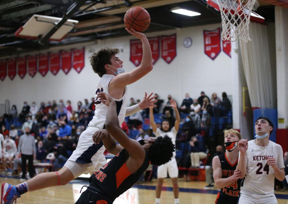 Roy C. Ketcham's Owen Paino takes a layup against White Plains' Menzy Carden during Friday's game in Wappingers Falls on December 10, 2021.