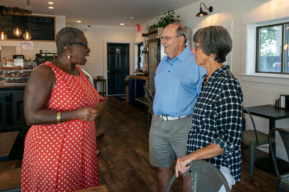 Former Framingham Mayor Yvonne Spicer speaks with former state Sen. David Magnani and his wife, Nanette, at the Franklin St. Cafe on Franklin Street in Framingham, Aug. 12, 2022.