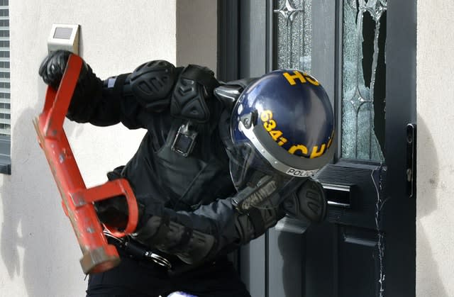 Police carrying out a raid during a crackdown on county lines drugs gangs