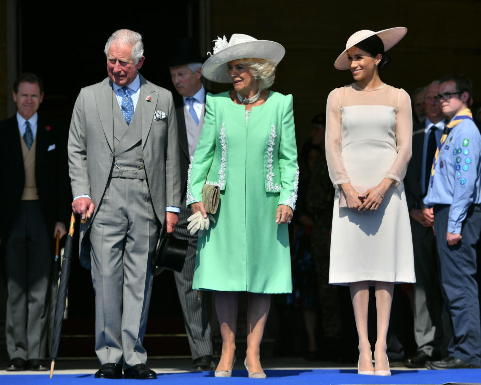 Charles, Camilla and Meghan at a Buckingham Palace garden party last summer [Photo: PA]